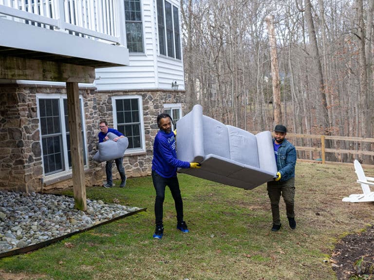 Two men carrying a sofa